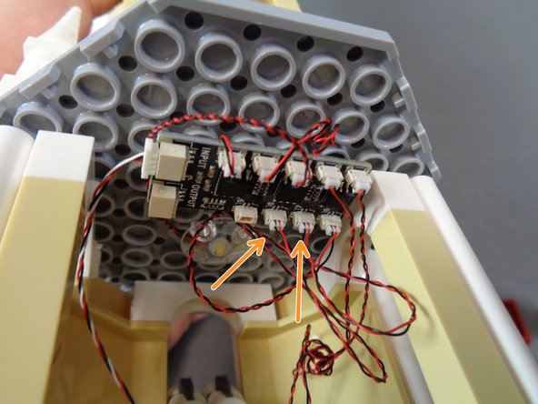 As shown by the orange arrows in the third photo, connect the two mirror lights to plugs #7 and #8 on the BRANCH09X adapter board.