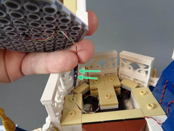 As shown in the first photo for this step, you should have a male black connecting plug (with gold pins) coming from underneath the top section and a female black connecting plug (without gold pins) coming from the top of the middle section.