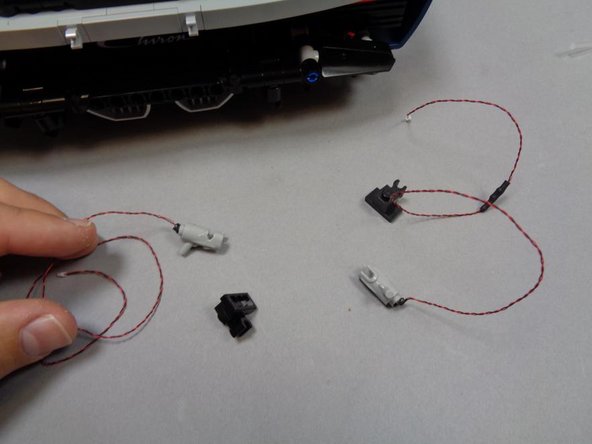 Carefully attach the Brickstuff &quot;blaster&quot; parts to the black brackets.