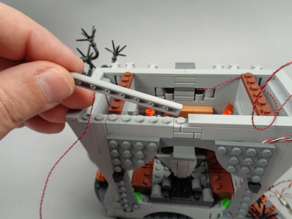 Turn the hall around, and remove the long tile on the left rear side of the hall as shown in the first photo for this step.