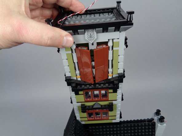 Gently but firmly press down on the top of the tower and check for any gaps in bricks along the sides where the tower separated, to make sure the tower is fully re-attached.