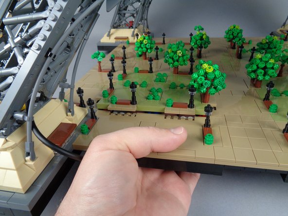 Carefully press up from underneath the bottom of your Tower base to loosen a panel.  You may need to press hard at first to loosen it.