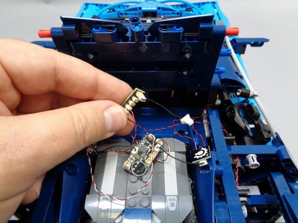 As shown in the first photo, carefully connect the two tail light plugs to any two of the small plugs on the BRANCH15 adapter board.