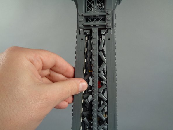 As shown in the photos for this step, attach the top of strip #2 to the tower frame, and re-position brace elements as needed to make room for the LED lights and strip.
