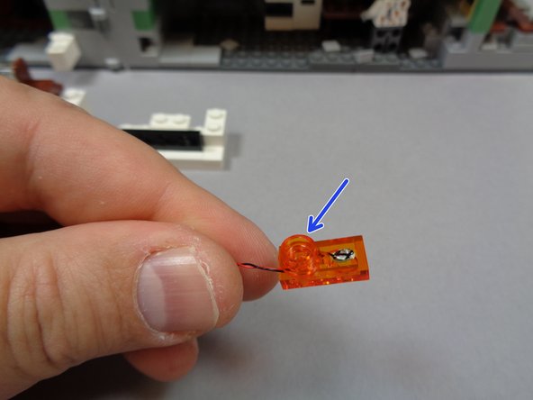 Make sure the light faces upward toward the top of the plate, and that the light wire passes toward the back of the plate as shown in the second photo.