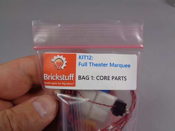 Remove the four pre-lit replacement front lights from Bag 1.  These will look like the parts shown in the second photo for this step.