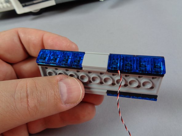 As shown by the orange circle and orange rectangle in the first photo, remove the center 1x2 slope and the 1x1 &quot;cheese slope&quot; immediately to the right of center.