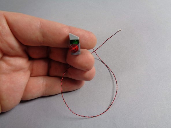 Replace the transparent red round plate as shown in the third photo.  You should now have a re-assembled control panel with one of the new cool white Pico LED lights inside.