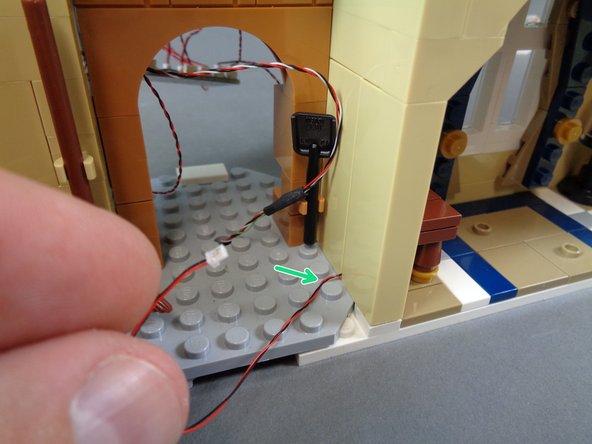 Leave a little slack in the wire behind the table.  This will make it easier to re-attach the tan pillar without pulling the wire.