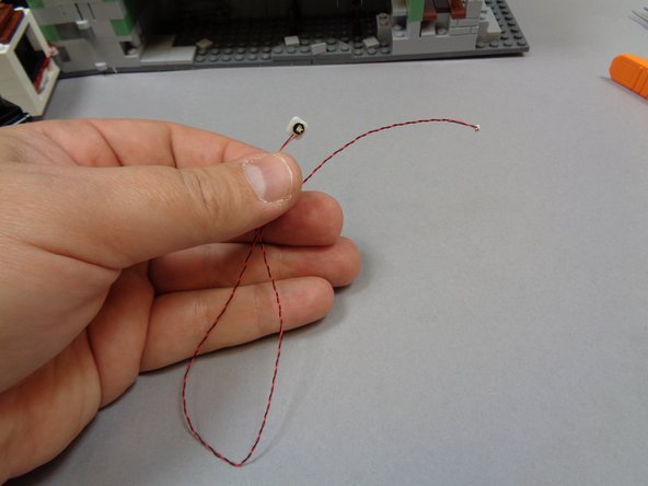 Take the last orange Pico LED light with 12&quot; (30.4cm) wire and attach a small sticky square to the back as shown in the first photo.