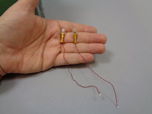 Inside the small bag of orange LED lights, there should be two replacement sconces with orange Pico LED lights pre-mounted as shown in the third photo.