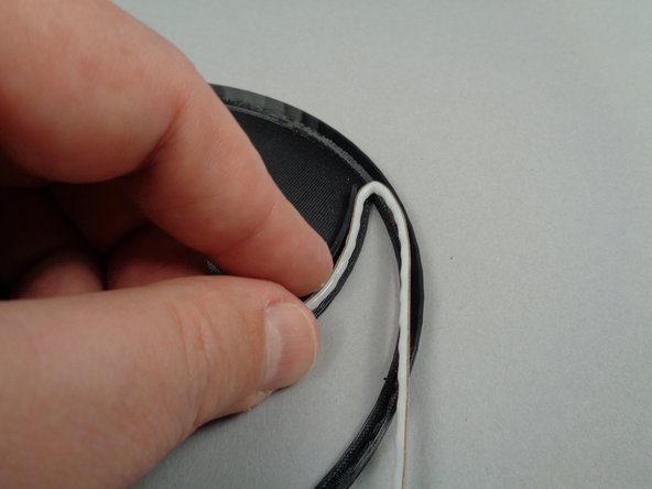 As shown in the second photo for this step, carefully bend the strip back on itself for the top fold, then along the round edge.