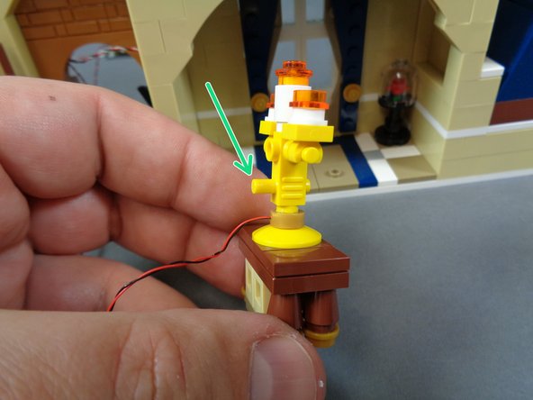 As shown by the green arrow in the third photo, make sure to mount the candelabra so the yellow pin is facing toward the back.