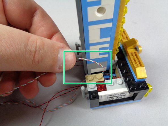 As shown by the green arrows in the second photo for this step, make sure the top marquee light wire is off to one side when re-attaching-- this will prevent it from getting pinched in the clips below.