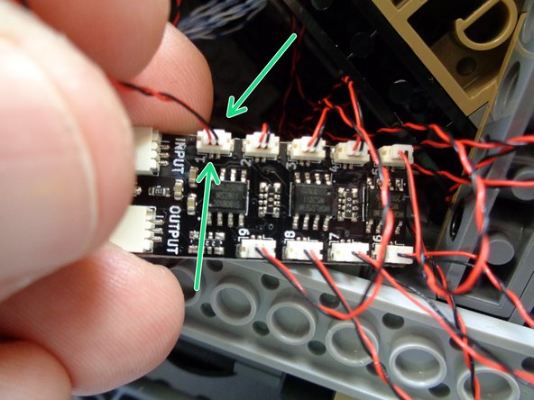 As shown by the green arrows in the first photo, connect the green LED to plug #1 (the last available plug) on the BRANCH09X adapter board with the window lights connected to it.