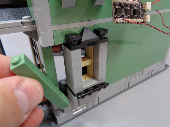 As shown in the first and second photos, remove the green wall section next to the kitchen window, then remove the window assembly itself.