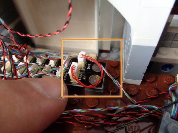 As shown by the orange square in the second photo, connect the BRANCH17 adapter with the fireworks attached to the BRANCH17 adapter with the color-changing spotlights attached.  The IN connector on the fireworks BRANCH17 adapter should be connected to the OUT connector on the color-changing spotlight BRANCH17 adapter as shown.