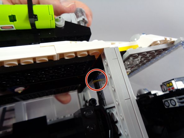 If you do want to use the steering axle, you will need to re-insert it now and make sure it does not break any of the front light wires.