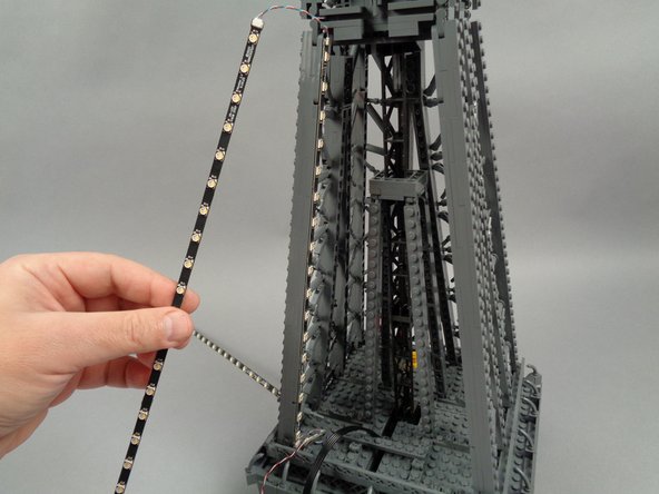 Leave the top LED strip section (the 20-LED strip) hanging loose for now as shown in the second photo).