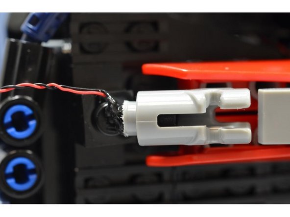 Mount both &quot;blaster&quot; assemblies, one on the left side and the other on the right side of the rear of the car.