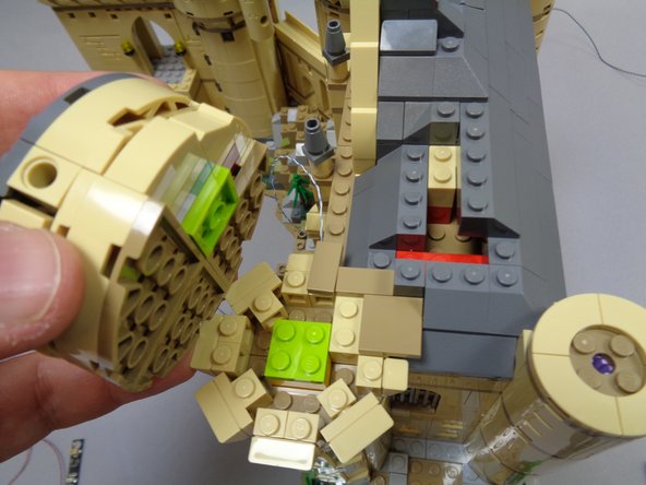 As shown in the photos for this step, carefully remove the top sections of the tower.  There are two parts: one large part (first photo) and one smaller part (second photo).