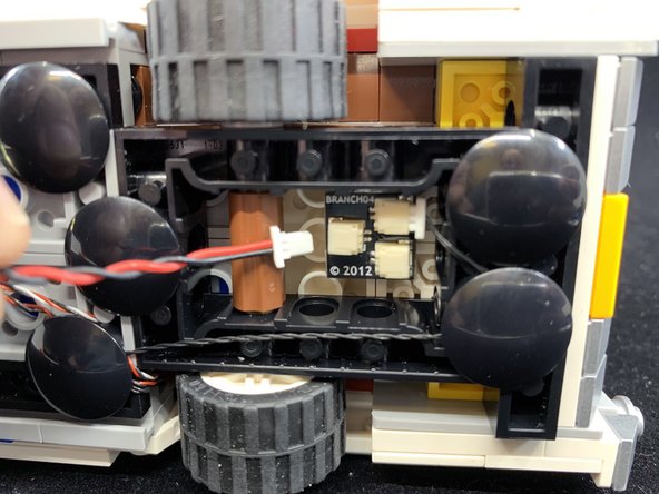 As shown in the second photo, attach the USB power cable that came with your kit to one of the open plugs on the BRANCH04 adapter underneath the car.