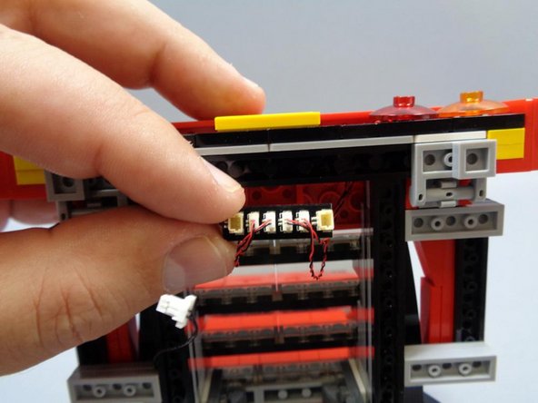Connect the two red two orange tail lights to the small plugs on the BRANCH15 4-port adapter included with this kit.