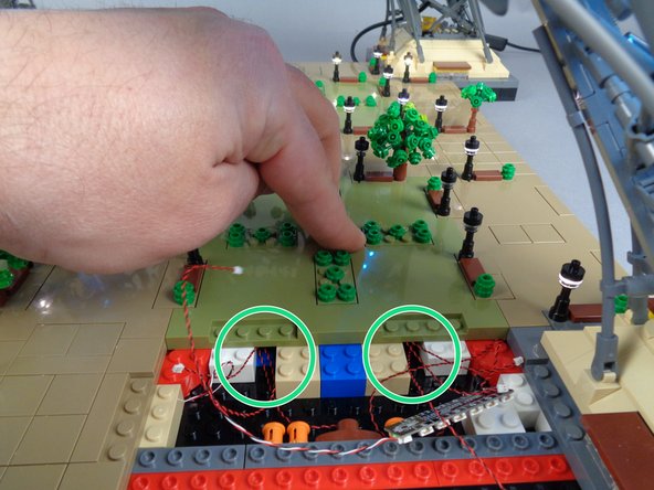 As shown in the first photo for this step, position Panel 4 to be re-attached but do not press down yet.