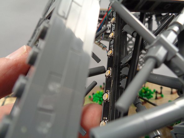 Using two fingers, gently press the front and back sides of the pillar to attach the light strip to the pillar.