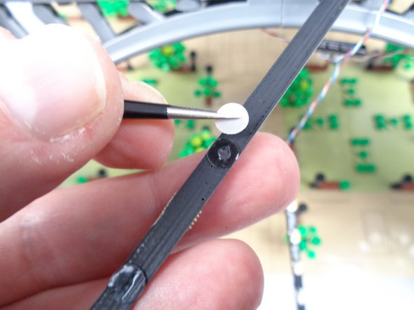 Begin by removing the backs of the four sticky dots on the first light strip as shown in the first photo for this step.