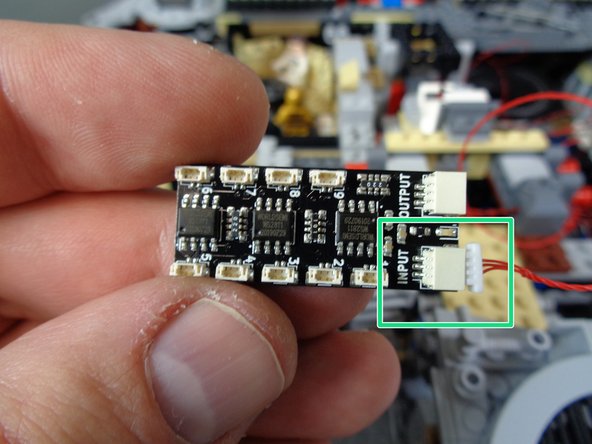 If you connected the lower laser cannon in the previous steps, you will have all nine small plugs on the BRANCH09X adapter board filled.  The first photo shows plugs #8 and #9 empty-- this is ok if you did not install the lower laser cannon.  You can always add it later if you want to.