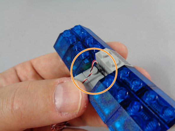 The orange circle in the first photo of this step shows another angle of the &quot;T&quot; shaped part bent upward, and the three wires bent downward.