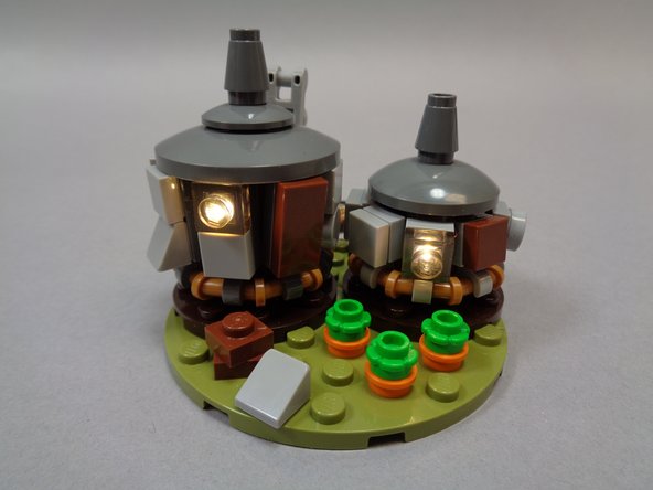 As shown in the third photo, re-attach the two roofs.  Your hut is now complete.