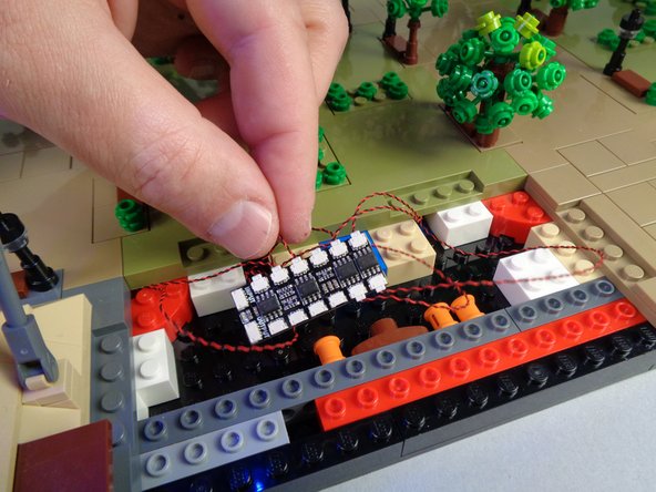 Next, connect the eight lamp posts from Panel 1 and Panel 1L to eight plugs on the BRANCH12X driver board as shown in the first photo for this step.