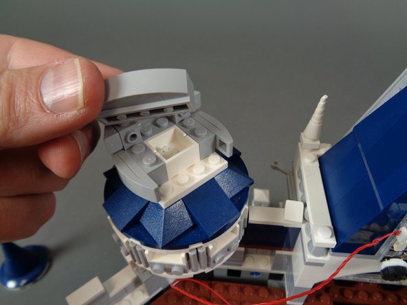 As shown in the photos for this step, remove the top and rear parts from the second tower so you can mount the second LED light.