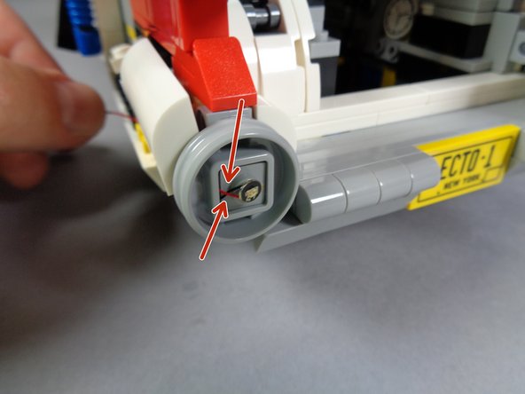 Remember to leave a little slack and pinch the wire along the side of the stud on the plate under the LED light-- this will help the transparent red dish remain attached to the tail light frame.