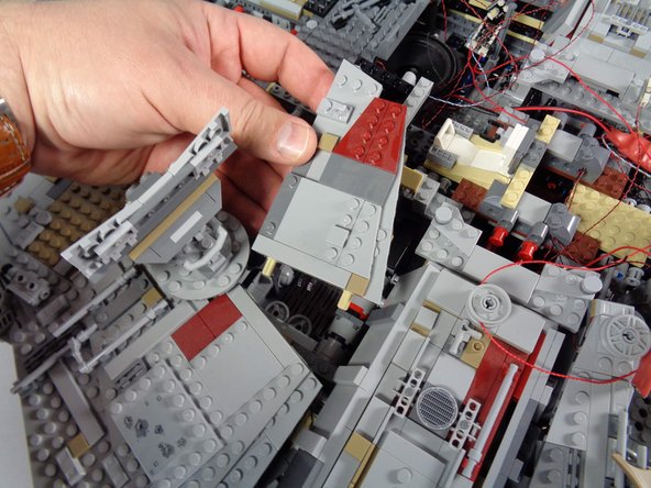 As shown in the first photo for this step, remove the top panel covering the room with the Dejarik (chess) table.