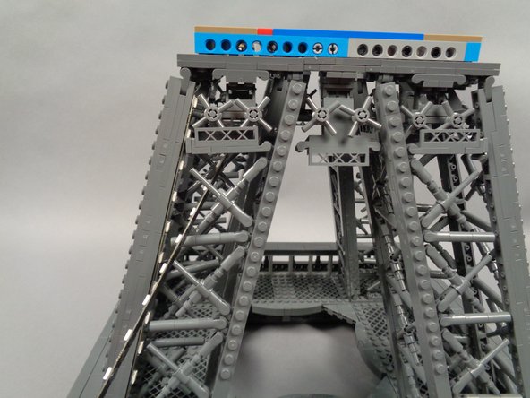 As shown in the first photo for this step, carefully pass the end of the second light strip through the outside of the pillar.