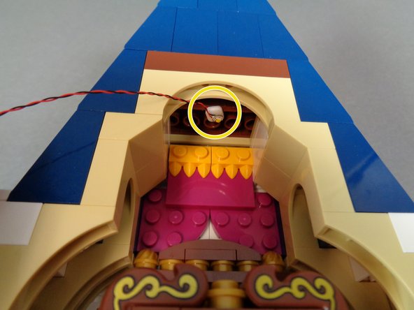 Take one of the warm white Pico LED lights from the bag and attach a small sticky square (also in the bag) to the LED light as shown in the second photo.