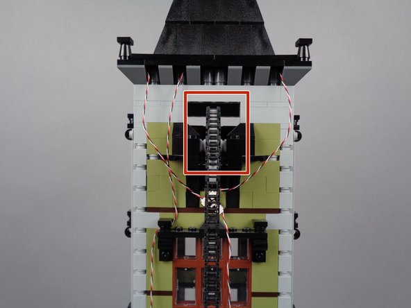 Perform one final wire clearance check to make sure all wires are outside the area shown by the red rectangle in the photo for this step.  It is critical to make sure no wire can bend close enough to the gear or chain to get pulled or caught when the elevator moves.