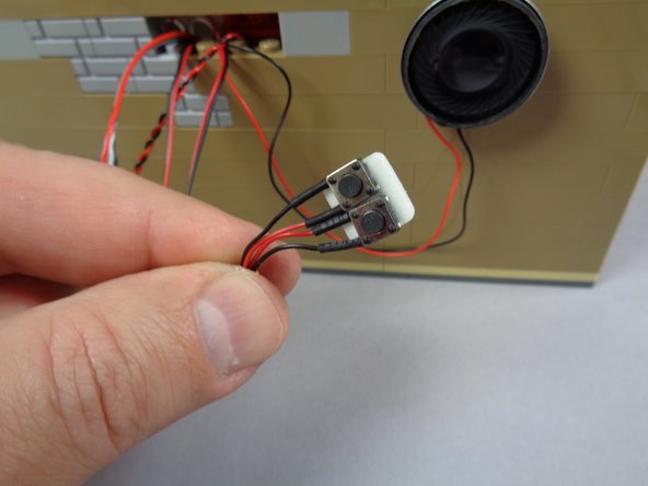 You don't have to attach the buttons this way-- you could leave them hanging loose or conceal elsewhere in the cinema.