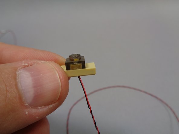 Next, as shown in the second photo, make sure each pre-mounted light is flat against the top of the jumper stud.