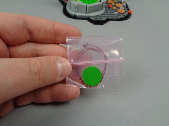 As shown in the second photo, your Bag 3 contains one small bag with green dot.  Take out the two green LED lights from this bag.