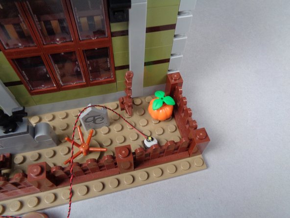 As shown in the third photo, replace the fencing section and run the LED Light wire behind the fences toward the left.