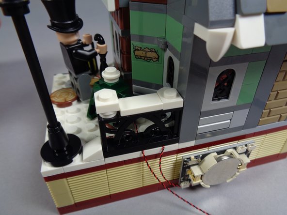 As shown in the third photo, re-attach the black gate.