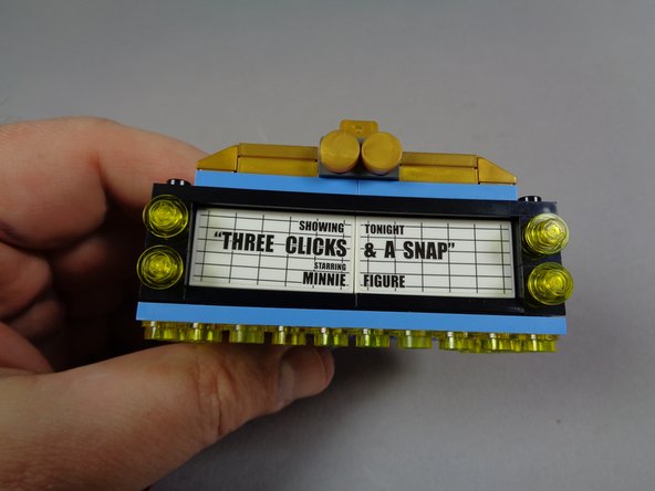 As shown in the three photos for this step, re-attach the two front and two side tiles on the marquee.