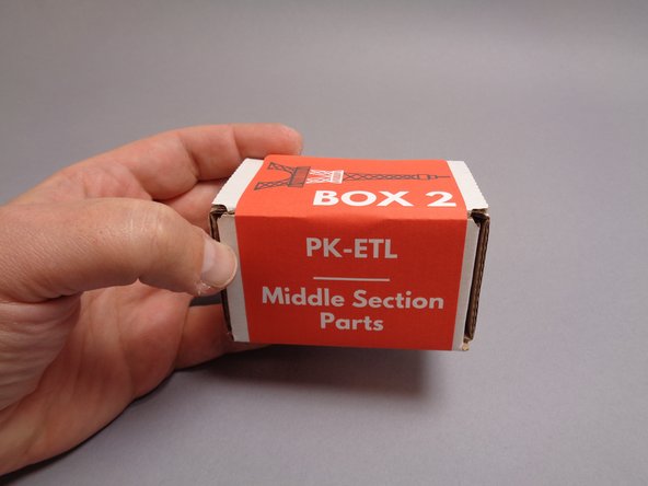 As shown in the first photo for this step, you will continue installation of your light kit with the parts included in Box 2.