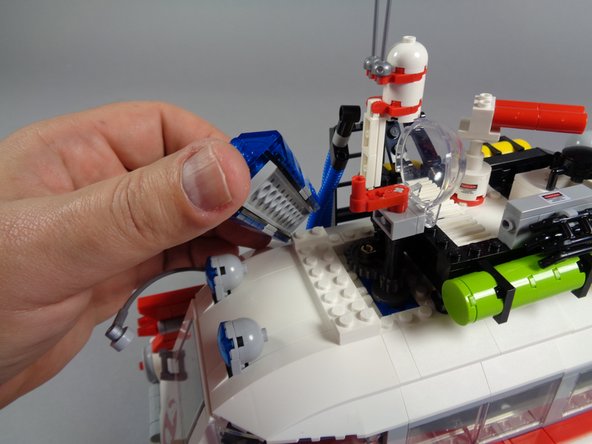 As shown in the third photo, remove the large strobe/steering brick along with its axle.