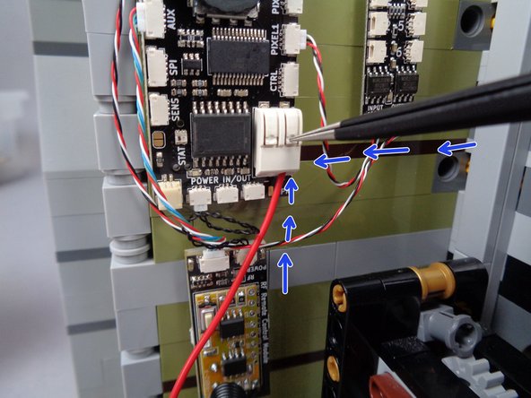 As shown in the first photo for this step, take the two black round 1x1 LEGO plates from the LEGO parts bag in BOX #1 and attach them to the mansion's baseplate, making sure they are SIX studs apart as shown by the green line in the photo.