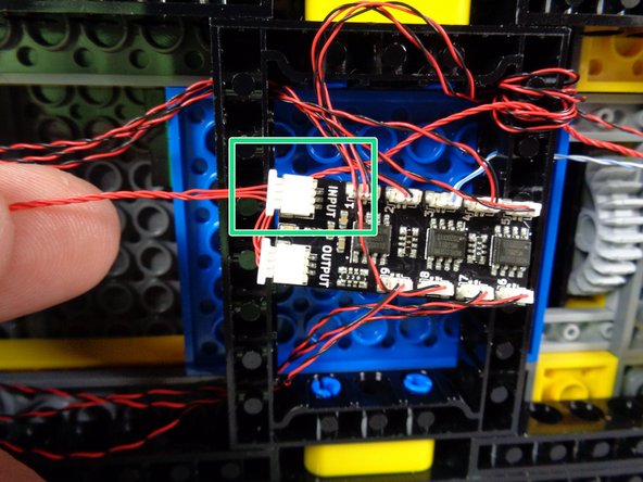 Take the last red control wire from the &quot;MAIN CHASSIS PARTS&quot; bag, and connect one end to the plug labeled INPUT on the BRANCH09X adapter.